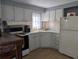 Efficient kitchen with white cabinetry, updated appliances, and ample counter space, perfect for meal preparation at 248 Outer E Dr, Venice, FL 34285
