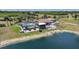 Waterfront home boasts a screened pool, patio, and well-maintained landscaping, creating a serene oasis at 24805 Nova Ln, Punta Gorda, FL 33980