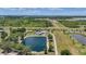 Spacious property featuring multiple ponds, a home with a pool, and lush greenery in a serene setting at 24805 Nova Ln, Punta Gorda, FL 33980
