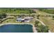 Charming waterfront property featuring a screened pool, lovely landscaping, and scenic pond views at 24805 Nova Ln, Punta Gorda, FL 33980