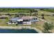 Beautiful waterfront home featuring a screened pool, patio, and well-maintained landscaping at 24805 Nova Ln, Punta Gorda, FL 33980