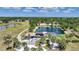 Beautiful waterfront property featuring solar panels, screened pool, mature landscaping, and circular driveway at 24805 Nova Ln, Punta Gorda, FL 33980