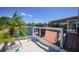 Inviting deck with a grill, lush greenery, and scenic lake views, ideal for outdoor gatherings at 24805 Nova Ln, Punta Gorda, FL 33980
