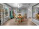 Dining room featuring a wooden table set, hard wood flooring, and floral print drapes at 24805 Nova Ln, Punta Gorda, FL 33980