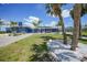 Charming blue single-story home with tropical landscaping, and a sunny driveway at 24805 Nova Ln, Punta Gorda, FL 33980