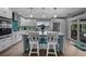 Contemporary kitchen with an island, white cabinets, pendant lights, and modern appliances for an upscale cooking experience at 24805 Nova Ln, Punta Gorda, FL 33980