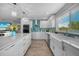 Modern kitchen featuring white cabinetry, quartz countertops, and a stylish backsplash, ideal for culinary enthusiasts at 24805 Nova Ln, Punta Gorda, FL 33980