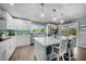Stylish kitchen featuring white cabinetry, a central island, and stainless appliances, perfect for entertaining and cooking at 24805 Nova Ln, Punta Gorda, FL 33980