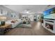 Bright living room featuring tile flooring, a white sofa, and a fireplace with a TV at 24805 Nova Ln, Punta Gorda, FL 33980