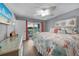 Comfortable main bedroom featuring a ceiling fan, slider doors and beach decor at 24805 Nova Ln, Punta Gorda, FL 33980