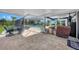 Spacious screened-in patio with tiled floors, a sitting area, and a view of the pool and surrounding landscape at 24805 Nova Ln, Punta Gorda, FL 33980
