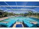 Enclosed pool area with lounge chairs, dining set, and scenic lake views at 24805 Nova Ln, Punta Gorda, FL 33980