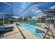 Outdoor pool with built-in spa and scenic views, surrounded by lounge furniture at 24805 Nova Ln, Punta Gorda, FL 33980