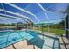 Screened pool area featuring inviting lounge chairs and a serene view of the lake at 24805 Nova Ln, Punta Gorda, FL 33980