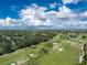 Stunning aerial view showcasing a golf course and the sprawling community on a sunny day at 26 Saint Croix Way, Englewood, FL 34223