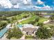 Gorgeous aerial view highlighting the golf course and community clubhouse surrounded by tropical trees at 26 Saint Croix Way, Englewood, FL 34223