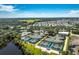 Expansive aerial view of the community featuring tennis and pickleball courts near lush greenery at 26 Saint Croix Way, Englewood, FL 34223