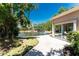 Beautiful backyard featuring a tranquil pond view and a paved patio, perfect for relaxing outdoors at 26 Saint Croix Way, Englewood, FL 34223