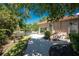 Stunning backyard featuring a serene pond view, lush landscaping, and a paved patio at 26 Saint Croix Way, Englewood, FL 34223