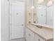 Bathroom with a stone countertop, framed mirror, pendant lighting, and white cabinets at 26 Saint Croix Way, Englewood, FL 34223