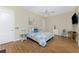 Cozy bedroom with hardwood floors, ceiling fan, and decoratively painted accent pillows at 26 Saint Croix Way, Englewood, FL 34223