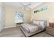 Bedroom with light wood floors, a large window, and a ceiling fan at 26 Saint Croix Way, Englewood, FL 34223