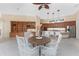 Bright breakfast nook featuring white wicker chairs, and an open view to the kitchen area with stainless steel appliances at 26 Saint Croix Way, Englewood, FL 34223