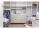 Walk-in closet featuring custom built-in shelves, drawers, and hanging racks at 26 Saint Croix Way, Englewood, FL 34223