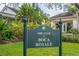 Exterior of The Club at Boca Royale, featuring well-maintained landscaping and signage at 26 Saint Croix Way, Englewood, FL 34223
