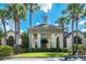 Luxurious clubhouse entry featuring classic architecture, stately columns, and tropical landscaping at 26 Saint Croix Way, Englewood, FL 34223