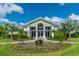 Exterior view of the community clubhouse, featuring a lush lawn and welcoming entrance at 26 Saint Croix Way, Englewood, FL 34223