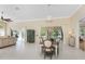 Sun-filled dining area featuring tile floors, neutral walls, and a view of a lake through large windows at 26 Saint Croix Way, Englewood, FL 34223