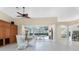 Bright dining area features a ceiling fan and sliding glass doors to the screened-in pool at 26 Saint Croix Way, Englewood, FL 34223