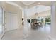 Open-concept dining room features tile flooring, white columns, water views from large windows, and stylish chandelier at 26 Saint Croix Way, Englewood, FL 34223