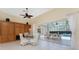 Bright dining area features a ceiling fan and sliding glass doors to the screened-in pool at 26 Saint Croix Way, Englewood, FL 34223