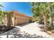 Long paved driveway leading to a spacious garage and well-maintained home exterior at 26 Saint Croix Way, Englewood, FL 34223