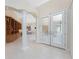 Elegant entryway with white tile floors, grand columns, built in cabinet, and decorative glass double front doors at 26 Saint Croix Way, Englewood, FL 34223