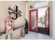 Foyer of home featuring a red door and wrought iron lettering on the wall at 26 Saint Croix Way, Englewood, FL 34223