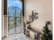 Foyer featuring high ceilings, black ornate metal gate, and beige walls at 26 Saint Croix Way, Englewood, FL 34223