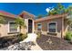 Charming home featuring a beautifully landscaped front yard and inviting entry with a black metal gate at 26 Saint Croix Way, Englewood, FL 34223