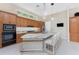 Spacious eat-in kitchen featuring granite countertops, stainless appliances and pendant lighting at 26 Saint Croix Way, Englewood, FL 34223