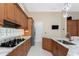 Gourmet kitchen featuring granite countertops, modern appliances, and sleek wooden cabinetry at 26 Saint Croix Way, Englewood, FL 34223