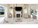 Bright and airy living room featuring a fireplace, tile floor, and neutral decor at 26 Saint Croix Way, Englewood, FL 34223