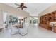 Spacious living room with tile floors and sliding glass doors that provide access to outdoor living spaces at 26 Saint Croix Way, Englewood, FL 34223