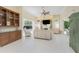 Bright living room with open access to pool area, a built-in bar area, and tile flooring at 26 Saint Croix Way, Englewood, FL 34223