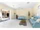 Bright living room with tile flooring, comfortable seating, ceiling fan and an open floor plan at 26 Saint Croix Way, Englewood, FL 34223