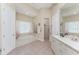 Bright bathroom with dual vanities, a soaking tub, a walk-in shower, and tile floors at 26 Saint Croix Way, Englewood, FL 34223