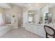 Bright bathroom with dual vanities, a soaking tub, a walk-in shower, and lots of natural light at 26 Saint Croix Way, Englewood, FL 34223