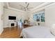 Sun-filled main bedroom featuring wood floors and a view of the backyard through a large window at 26 Saint Croix Way, Englewood, FL 34223