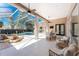 Covered patio with seating, dining area, and views of the screened-in pool and lush landscaping at 26 Saint Croix Way, Englewood, FL 34223